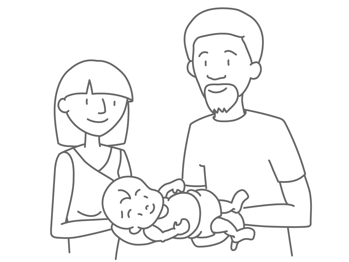Two new parents holding a baby.