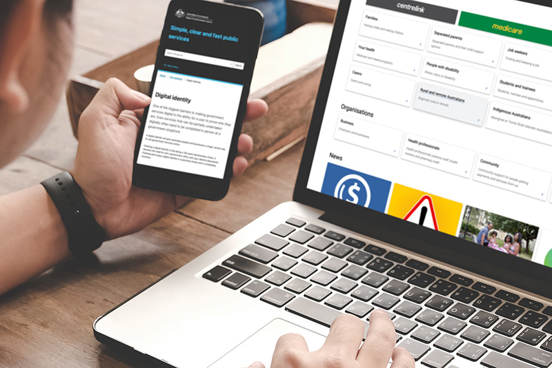 A user holding their mobile device in their left hand while using a website with their right hand.