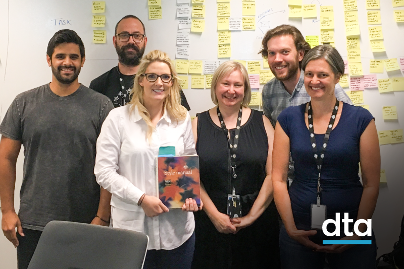 The DTA Style Manual team holding a printed copy of the Style Manual