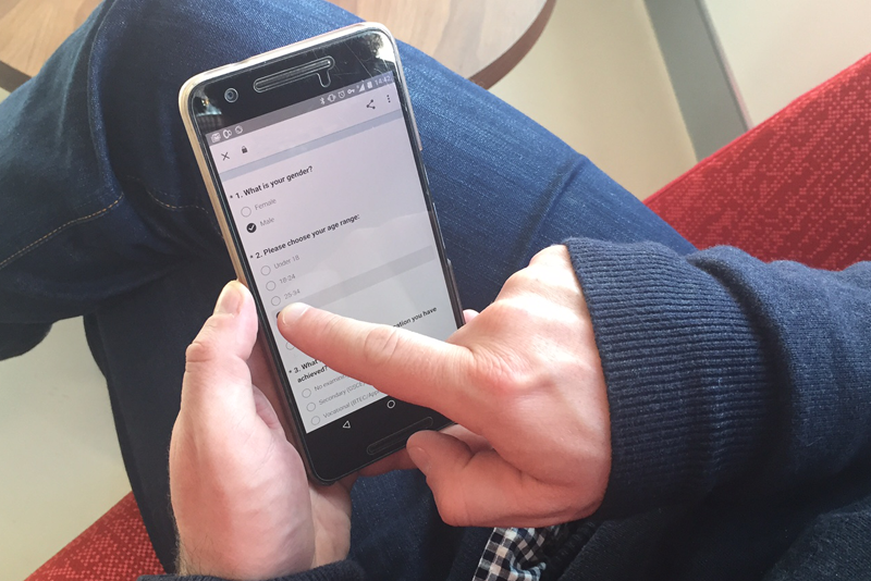 A user filling out a survey on a smart phone.