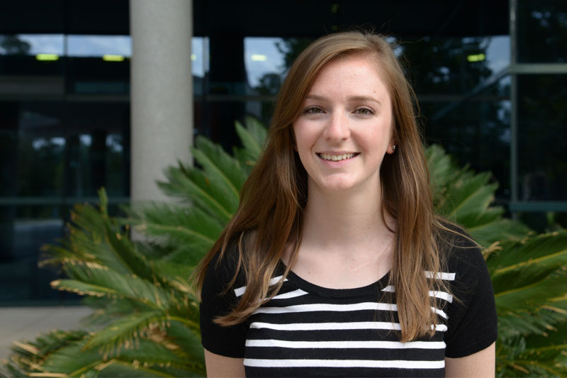 Eloise Aitken, ICT graduate stands in front of the Geoscience Australia building.