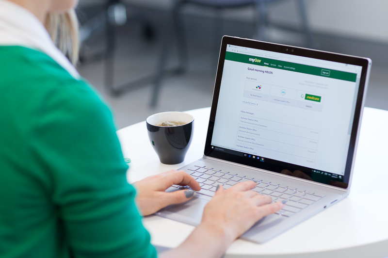 A user navigates the new look myGov on a laptop.