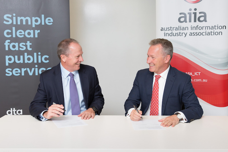 Gavin Slater, CEO of the DTA and Rob Fitzpatrick, CEO of the AIIA signing the MoU.